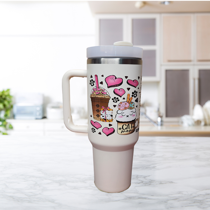 Cat Mom 40oz Tumbler with Handle featuring adorable cat illustrations alongside various coffee types and cups adorned with pink hearts, symbolizing a loving connection between cats and coffee.